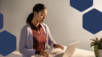 A woman sitting at a desk using a laptop